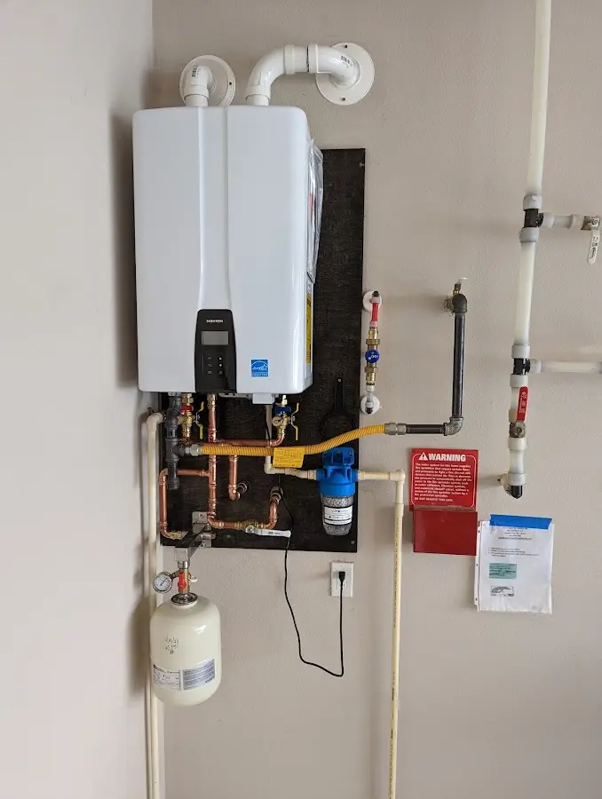 Professional plumber installing copper piping in a Crest Hill home